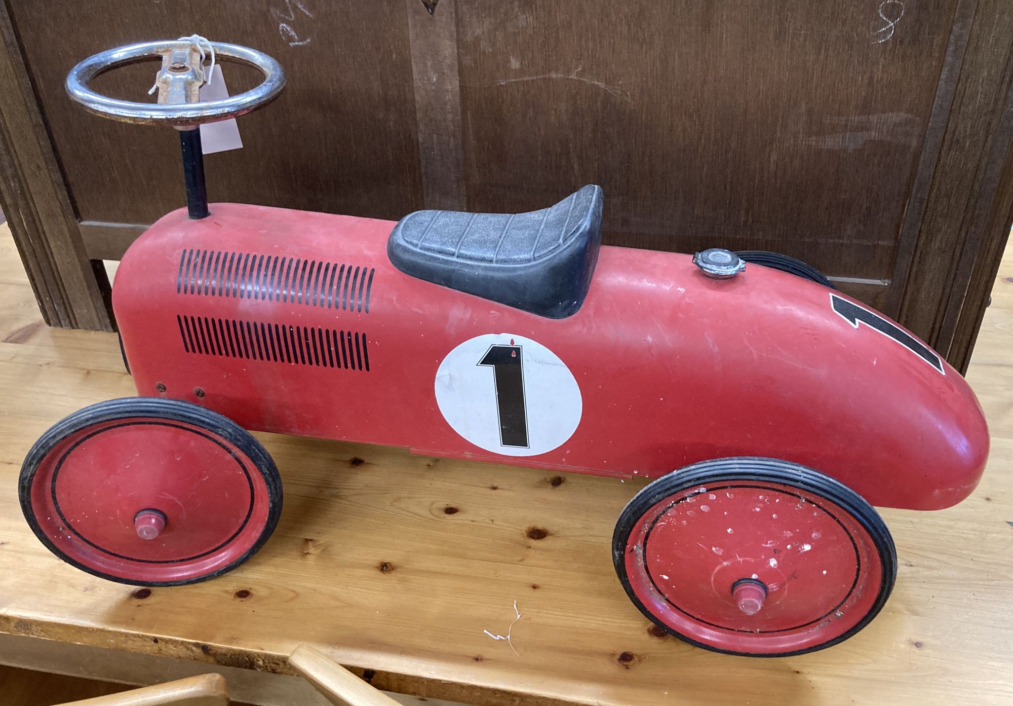 A child's vintage style painted metal sit on toy racing car, length 76cm